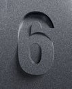 Slanted 3d font engraved and extruded from the surface, number 6