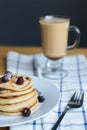 Slapjack or oladyi with blackberry, frozen berries on plate, fork and coffee Royalty Free Stock Photo