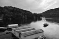 Slapy, Czech republic - August 04, 2018: Slapy dam with police boat moving to harbor with hangars during summer evening storm Royalty Free Stock Photo