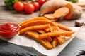 Slate board with sweet potato fries on table Royalty Free Stock Photo