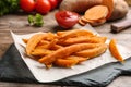 Slate board with sweet potato fries on table Royalty Free Stock Photo