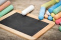 Slate with copyspace and colorful crayon on wooden table