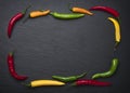 Slate framed by colorful chili peppers.