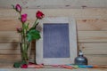 slate, pastel and roses on the pinewood table Royalty Free Stock Photo