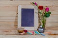 slate, pastel and roses on the pinewood table Royalty Free Stock Photo