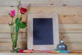 slate, pastel and roses on the pinewood table Royalty Free Stock Photo