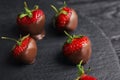 Slate plate with chocolate covered strawberries on table Royalty Free Stock Photo