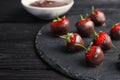 Slate plate with chocolate covered strawberries on table Royalty Free Stock Photo