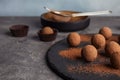 Slate plate with chocolate truffles on table Royalty Free Stock Photo