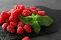 Slate plate with delicious fresh ripe raspberries on grey background Royalty Free Stock Photo