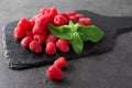Slate plate with delicious fresh ripe raspberries on grey background Royalty Free Stock Photo