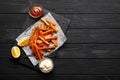 Slate plate with deliciously cooked sweet potatoes, rosemary, sauce and spices, herbs on a wooden Royalty Free Stock Photo