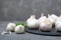 Slate plate with garlic bulbs on table Royalty Free Stock Photo