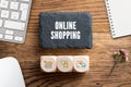Slate plate with message `online shopping ` and cubes with related icons
