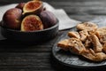 Slate plate with tasty dried figs on black wooden table. Space for text Royalty Free Stock Photo