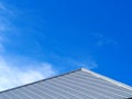Slate roof and slope with clouds and blue sky background.Tile roof of construction house with blue sky and cloud background. Royalty Free Stock Photo