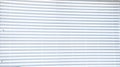 White slatted window blind closeup for background use