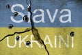 Slava UkrainI written on concrete wall with bullet holes and the ukrainan national flag. Royalty Free Stock Photo