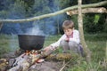 Slavic child in national clothes near the fire. Royalty Free Stock Photo