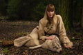 Slavonian girl and siberian husky in the deep forest