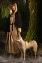 Slavonian girl and siberian husky in the deep forest