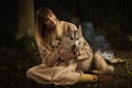 Slavonian girl and siberian husky in the deep forest