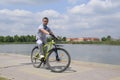 A man by the lake on a yellow mountain bike. A walk on the bike Royalty Free Stock Photo