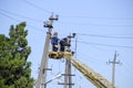 Electricians repair the power line with a lift. Repair work. Current repair of electrical wiring.