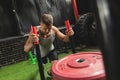 Strong sportsman during sled push exercise in the cross training gym