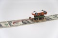 A sled ride on a dollar money road made of banknotes, with an inverted toy car Royalty Free Stock Photo
