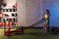 Sled rope pull woman pulling weights workout Royalty Free Stock Photo