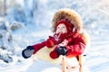 Sled and snow fun for kids. Baby sledding in winter park. Royalty Free Stock Photo