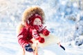 Sled and snow fun for kids. Baby sledding in winter park. Royalty Free Stock Photo