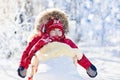 Sled and snow fun for kids. Baby sledding in winter park. Royalty Free Stock Photo