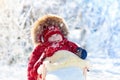 Sled and snow fun for kids. Baby sledding in winter park. Royalty Free Stock Photo