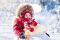 Sled and snow fun for kids. Baby sledding in winter park. Royalty Free Stock Photo