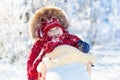 Sled and snow fun for kids. Baby sledding in winter park. Royalty Free Stock Photo