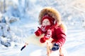 Sled and snow fun for kids. Baby sledding in winter park. Royalty Free Stock Photo