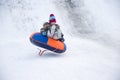 Sledding off a snow slide Royalty Free Stock Photo