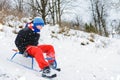 For a sledge down the boy in red pants is very happy Royalty Free Stock Photo