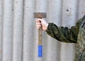 A sledgehammer in the hands of a man. A large hammer in his hands Royalty Free Stock Photo
