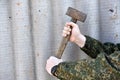A sledgehammer in the hands of a man. A large hammer in his hands Royalty Free Stock Photo