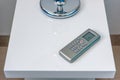 Sleek Air Conditioner Remote Control on Table Royalty Free Stock Photo