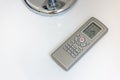 Sleek Air Conditioner Remote Control on Table Royalty Free Stock Photo