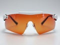 Sleek, amberlensed sports eyewear with a white bridge. Perfect for active lifestyles, this image evokes speed, performance, and a