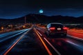sleek autonomous car driving on illuminated highway at night