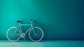 a sleek bicycle positioned against a solid, vibrant teal background.