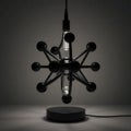 Modern black atomic table lamp with a clear light bulb, showcases minimalist design and elegant lighting Royalty Free Stock Photo