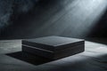 Elegant Black Box on a Dark Stone Surface with Dramatic Lighting Royalty Free Stock Photo