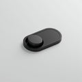 Sleek black button-like object on a light gray background. Rectangular base with Royalty Free Stock Photo